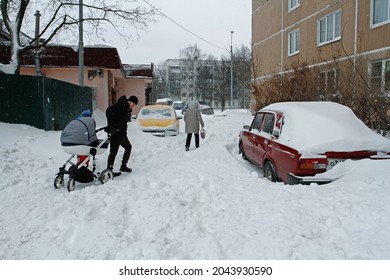 Vidnoe, Moscow region, Russia - February 13, 2021: People walk through the snowdrifts after night snowstorm in the yard in Vidnoe