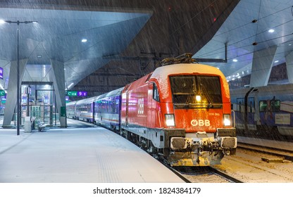 Vienna, Austria - 01.01.2020: A Red Siemens Taurus Locomotive With A Passenger Train Has Arrived At Vienna's Main Railway Station. Austrian Railways. Night Passenger Train. Intercity Express