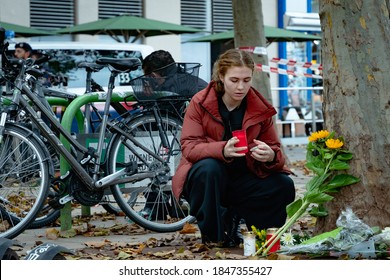 Vienna, Austria - 03 November 2020. Woman lays flowers in mourning over the victims of the previous nights terror attack in the city centre.