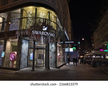 Vienna, Austria - 03-17-2022: View of the entrance of a Swarovski flagship store in the historic center of Vienna, Austria at shopping street Kärntner Straße by night with illuminated windows.