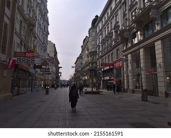 Vienna, Austria - 03-20-2022: View Of Popular Shopping Street Kärntner Straße In The Historic Center Of Vienna, Austria On Cloudy Day With People, Shops And Old Buildings.