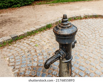 Vienna, Austria - 06.13.2022: Retro Borehole Pump On A Sunny Day, Old Manual Water Pump.