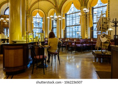 Vienna, Austria - April 5th 2018: A Lonely Lady Sitting In The Traditional Café Central, One Of Vienna's Most Famous And Most Prestigious Coffee Houses