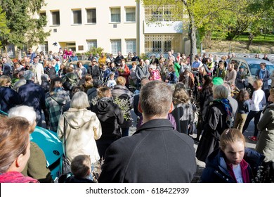 VIENNA, AUSTRIA - APRIL 9, 2017: Consecration of the palm branches with a large number of faithful on Palm Sunday outdoors with subsequent procession to the parish church in Gersthof.