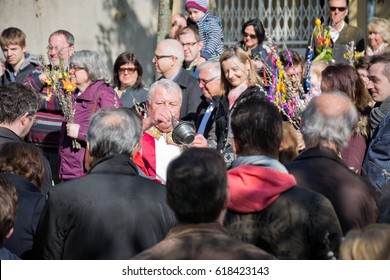 VIENNA, AUSTRIA - APRIL 9, 2017: Consecration of the palm branches with a large number of faithful on Palm Sunday outdoors with subsequent procession to the parish church in Gersthof.