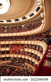 VIENNA, AUSTRIA - FEBRUARY, 2018: Interior Of The Vienna State Opera Auditorium With Audience. Man Looking Down From The Lateral Upper Tier Seats.