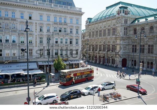 VIENNA, AUSTRIA -\
JULY 13, 2018: Old vintage building of tourist info in the citytown\
Helmut Zilk-Platz with tourist Big-Bus near the State Opera at\
Vienna city center\
Austria.