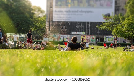 Vienna Austria May 3. 2018, People Sitting And Laying On Grass, Relaxing And Enjoying Sunny Weather, Low Angle View