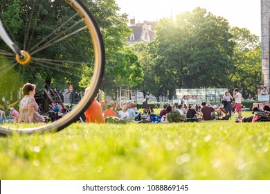 Vienna Austria May 3. 2018, People Sitting And Laying On Grass, Relaxing And Enjoying Sunny Weather, Low Angle View