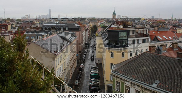 A Vienna cityscape from the\
roof of the building with the view on the rooftops of the\
buildings.