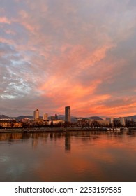Vienna Skyline Sunrise one the Danube. Orange Cloudy Sky. Water Reflection - Shutterstock ID 2253159585
