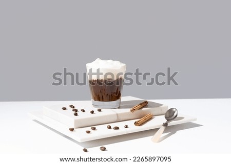 Viennese coffee with whipped cream and cinnamon on marble