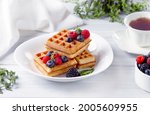 Viennese waffles, with berries, on a white table, breakfast, no people, horizontal,