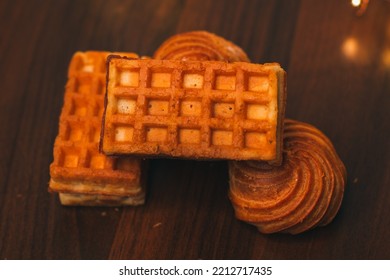 Viennese Waffles And Cookies Isolated On A Wooden Table. Delicious Homemade Cakes For Breakfast. Sweet Pastries. Waffles With Stuffing, Close-up. Bakery Products