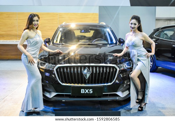 VIENTIANE, LAO - November\
10-18 2017: Unidentified females presenter at booth in the\
Vientiane International Motor Expo 2017 on November 10-18, 2017 in\
Vientiane, LAO PDR.