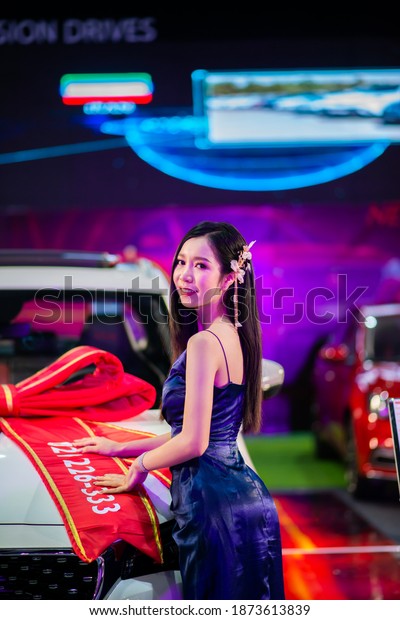 VIENTIANE, LAO - NOVEMBER 7 2020: Unidentified\
females presenter at booth in Vientiane International Motor Expo\
2020 in Vientiane, LAO\
PDR.