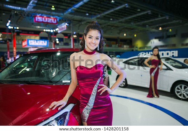 VIENTIANE, LAO - SEPTEMBER 30\
2016: Unidentified females presenter at booth in the first\
Vientiane International Motor Expo 2016 on SEPTEMBER 30, 2016 in\
Vientiane, LAO PDR.