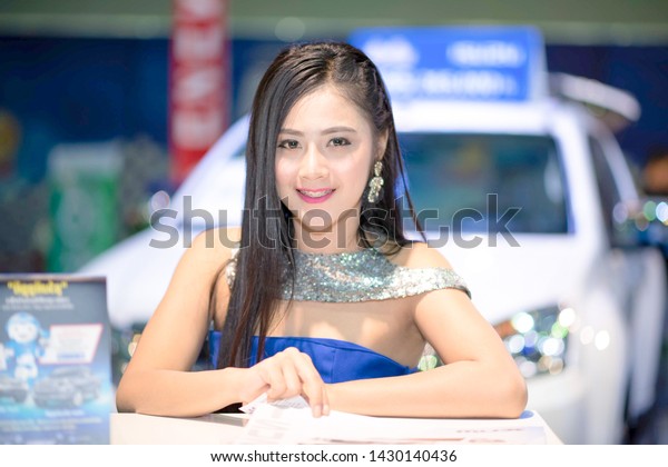VIENTIANE, LAO - SEPTEMBER 30\
2016: Unidentified females presenter at booth in the first\
Vientiane International Motor Expo 2016 on SEPTEMBER 30, 2016 in\
Vientiane, LAO PDR.