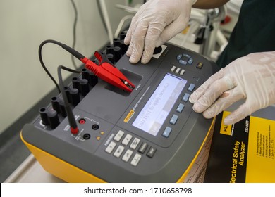 Vientiane / Laos - April 16, 2020: Biomass Engineer Preparing Analyzer For Electrical Safety Test In Hospital, It Is Use For Analyzing Medical Equipment To Unsure The Safety Use To Patients And Users.