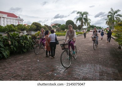 VIENTIANE, LAOS - AUG 20: Unidentified tourists ride bike visit Patuxai, It's a war monument. The Patuxai is dedicated to those who fought in the struggle for independence from France on Aug 20, 2011