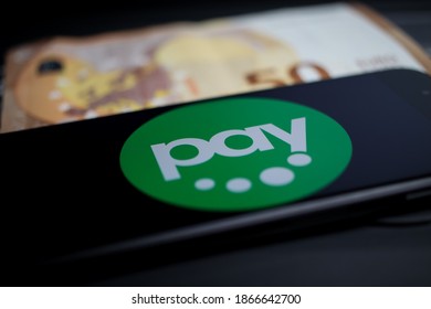 Viersen, Germany - April 9. 2020: Close up of mobile phone screen with logo lettering of Paydirekt payment provider on computer keyboard (selective focus on upper part of letter a)