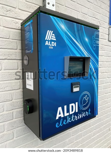 Viersen, Germany - December 9. 2021: View on\
free charging station for electric cars on parking lot of aldi\
store (focus on left front part of\
box)