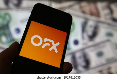 Viersen, Germany - February 9. 2020: Closeup Of Smartphone Screen With Logo Lettering Of Online Overseas Money Transfer Service Ofx, Blurred Banknotes Background (focus On Center Of Lettering)