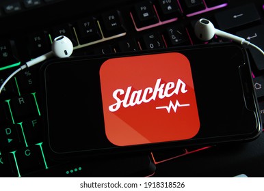 Viersen, Germany - February 9. 2021: Closeup of isolated smartphone screen with logo lettering of slacker internet radio on illuminated computer keyboard (focus on center of lettering)