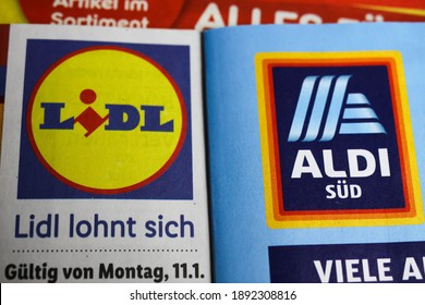 Viersen, Germany - January 9. 2021: Macro closeup of weekly printed advertising inserts from german discounter companies lidl and aldi (focus on word sud right)