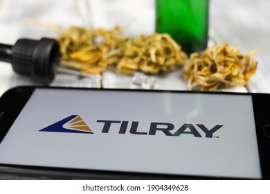 Viersen, Germany - January 9. 2021: Closeup of mobile phone screen with logo lettering of cannabinoid company tilray cannabis, blurred marijuana and pipette background (focus on letter R left)