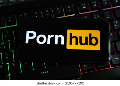 Viersen, Germany - January 9. 2022: Closeup of smartphone on computer keyboard with logo lettering of pornhub (focus on letter n)