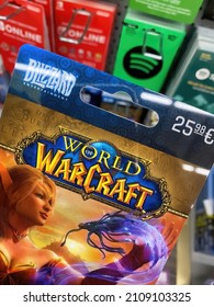 Viersen, Germany - January 9. 2022: Closeup of world of warcraft voucher gift card in shelf of german supermarket (focus on center of word world)