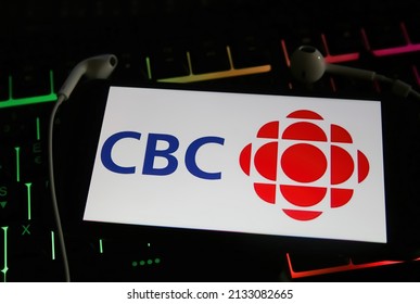 Viersen, Germany - January 9. 2022: Closeup of mobile phone with logo of canadian radio station cbc on computer keyboard (focus on center of reight letter C)