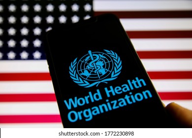 Viersen, Germany - July 8. 2020: Logo Of World Health Organization (WHO) On Mobile Phone Screen. Blurred Flag Of USA Background.