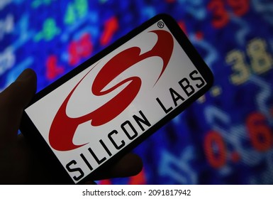 Viersen, Germany - June 6. 2021: Closeup Of Mobile Phone Screen With Logo Lettering Of Silicon Labs, Stock Market Chart Background (selective Focus On Central Upper Part Of Red Logo)