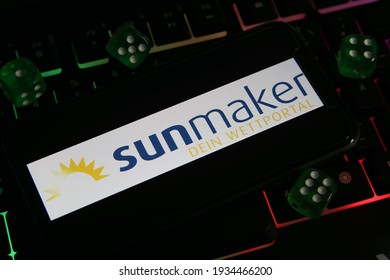 Viersen, Germany - March 1. 2021: Closeup of smartphone with logo lettering of online bet portal casino sunmaker on computer keyboard (focus on center of lettering)