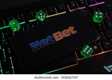 Viersen, Germany - March 1. 2021: Closeup Of Smartphone With Logo Lettering Of Netbet Online Gaming Casino On Computer Keyboard (focus On Letter B)