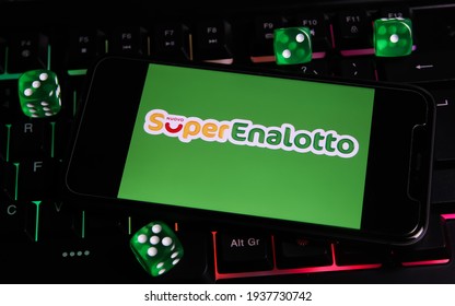 Viersen, Germany - March 1. 2021: Closeup of smartphone with logo letterin of italian lottery game superenalotto on computer keyboard (focus on center of lettering)