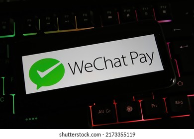 Viersen, Germany - March 9. 2022: Closeup Of Mobile Phone Screen With Logo Lettering Of Wechat Pay On Computer Keyboard 