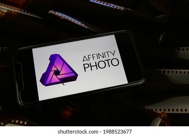 Viersen, Germany - May 9. 2021: Closeup of smartphone with logo lettering of affinity photo software on film negative strips (focus on center of word photo)