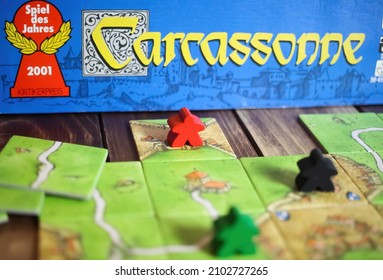 Viersen, Germany - May 9. 2021: Closeup Of Tile Based Original Strategy Board Game Carcassonne (selective Focus On Red Game Piece) 