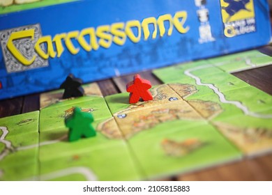 Viersen, Germany - May 9. 2021: Closeup Of Tile Based Original Strategy Board Game Carcassonne (selective Focus On Upper Paert Of Red Piece)