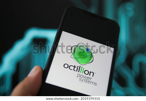 Viersen, Germany - May 9. 2021: Closeup of phone\
screen with logo lettering of octillion power systems, blurred\
power circuit background (selective focus on on center of green\
round logo)
