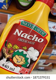 Viersen, Germany - October 8. 2020: Close Up Of Squeeze Cheese Nacho Sauce Bottle In Shelf Of German Supermarket (focus On Center Of Logo)