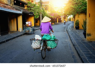 Vietnam People,Vietnamese Ride Bicycle On During Sunrise,woman With Vietnam Culture Traditional,Morning View Of Busy Street In Hoi An, Hoi An Is The World's Cultural Heritage Site ,Hoi An, Vietnam