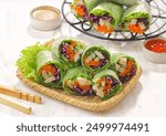 Vietnam Spring Roll. Vietnamese spring rolls, summer spring rolls, or salad spring rolls, a traditional dish in Vietnamese cuisine consisting of pork, shrimp, vegetables, bún, and other ingredients wr