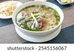 Vietnam traditional pho, Beef noodles. Pho Bo Soup with beef, rice noodles, ginger, lime, chili pepper in bowl. Vietnamese cuisine. Pho Noodle Soup