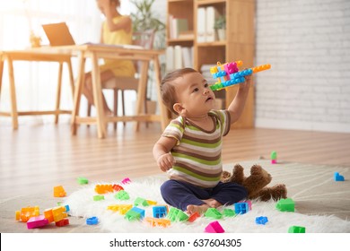 Vietnamese Baby Boy Playing With Plastic Blocks