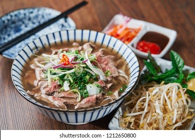 Vietnamese Phở Beef Noodle Soup Bowl with vegetable