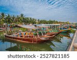 Vietnamese boats on the Thu bon river in the old town in Hoi An in Vietnam in summer